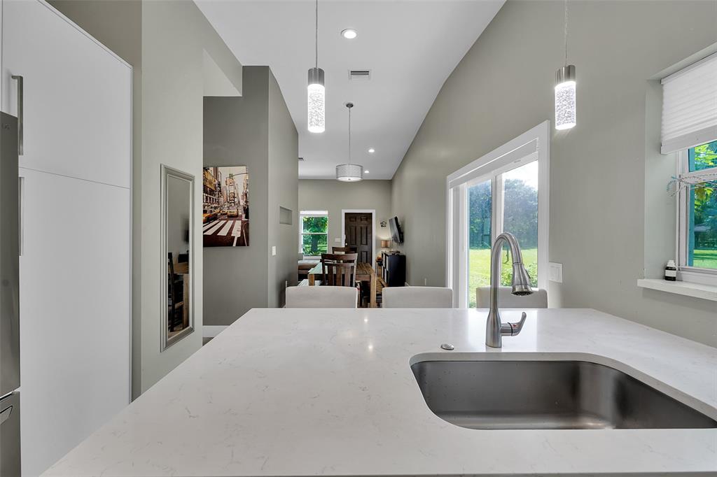 5351 Godfrey Road Parkland, FL 33067 - Photo 75 of 100 a kitchen with stainless steel appliances a sink and a refrigerator