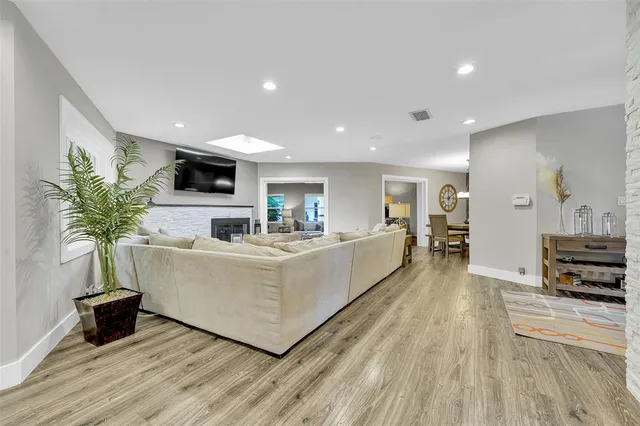 a kitchen with stainless steel appliances kitchen island granite countertop a refrigerator and cabinets