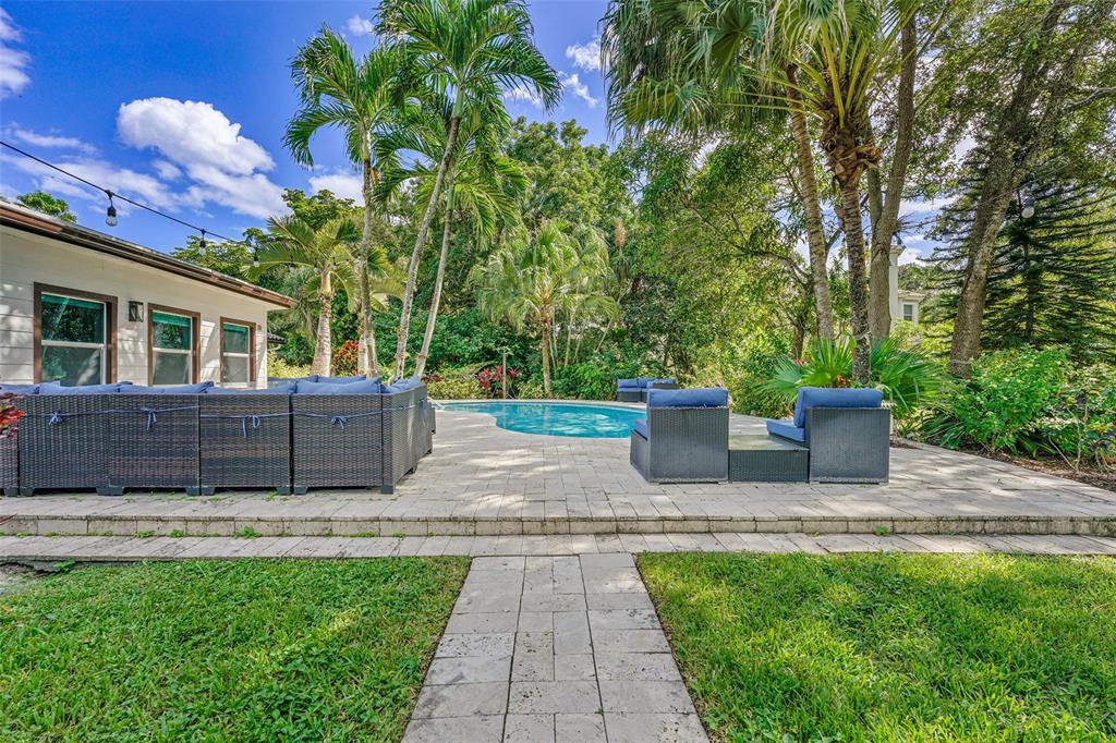 5351 Godfrey Road Parkland, FL 33067 - Photo 96 of 100 a view of a patio with table and chairs potted plants and large tree
