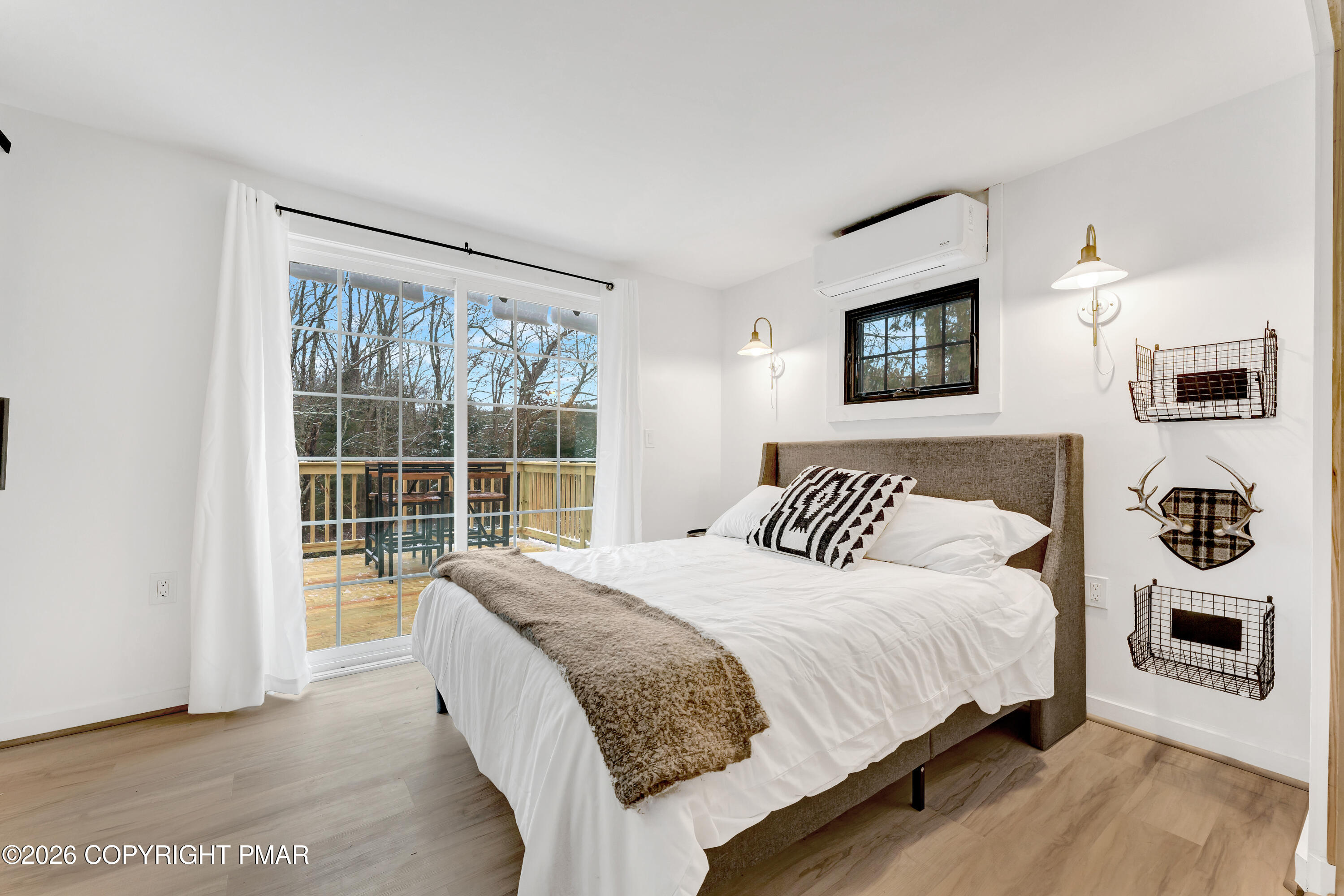 353 German Hill Road Shohola, PA 18458 - Photo 10 of 35 a bedroom with a large bed and a large window