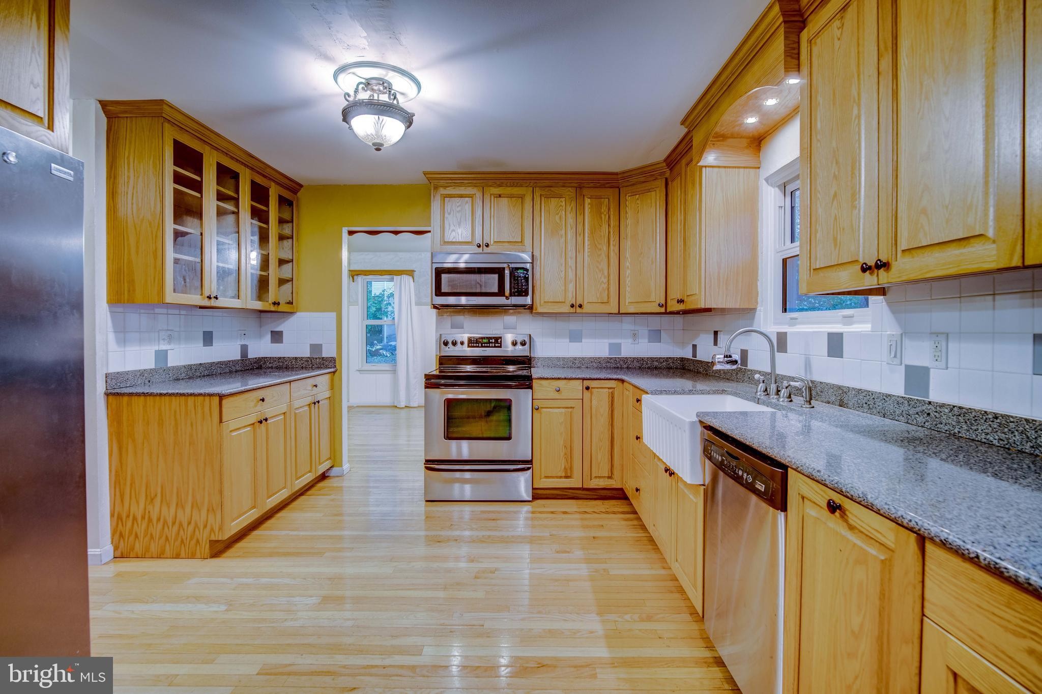 11431 Rawhide Road Lusby, MD 20657 - Photo 6 of 31 a kitchen with stainless steel appliances a stove sink and cabinets