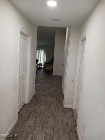 a view of a room with wooden floor and furniture