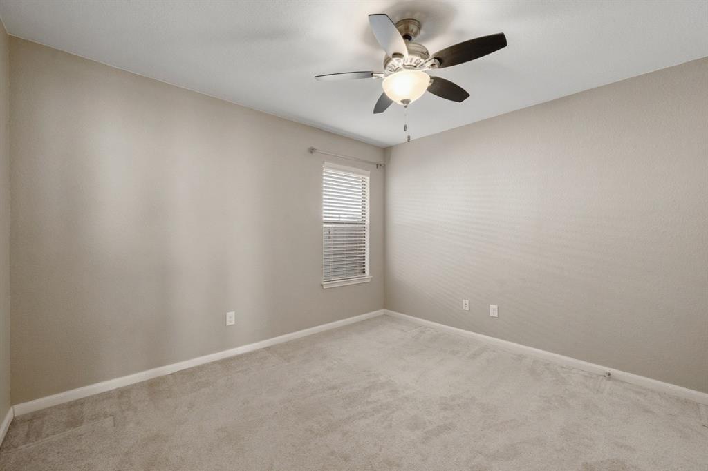 10445 Condor Loop Waco, TX 76708 - Photo 16 of 22 an empty room with a chandelier fan and windows