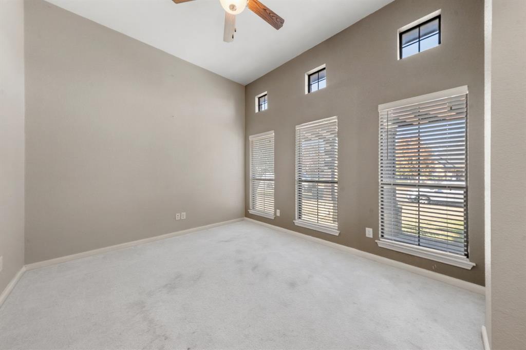 10445 Condor Loop Waco, TX 76708 - Photo 2 of 22 an empty room with windows and chandelier fan