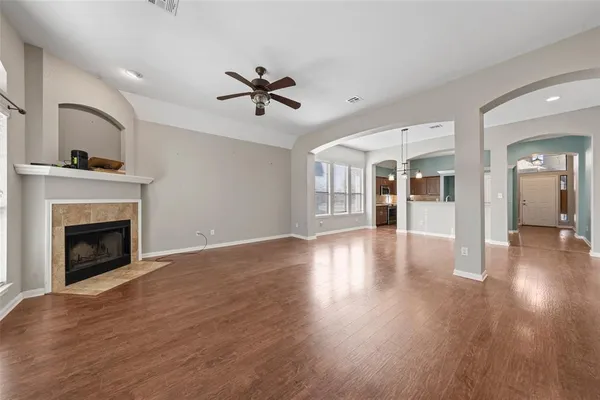 a view of a room with wooden floor and a fireplace