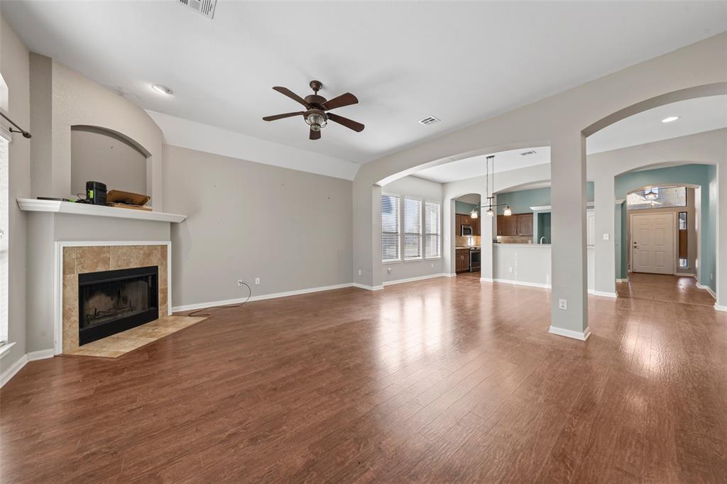 10445 Condor Loop Waco, TX 76708 - Photo 3 of 22 a view of a room with wooden floor and a fireplace