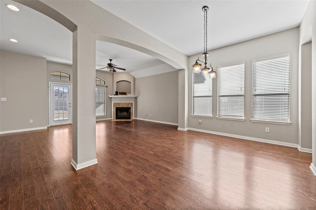 10445 Condor Loop Waco, TX 76708 - Photo 4 of 22 a view of a room with wooden floor fireplace and windows