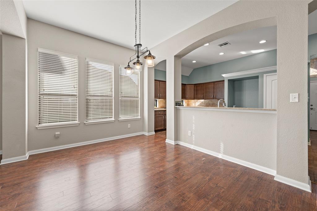 10445 Condor Loop Waco, TX 76708 - Photo 9 of 22 a view of an empty room with a window and wooden floor