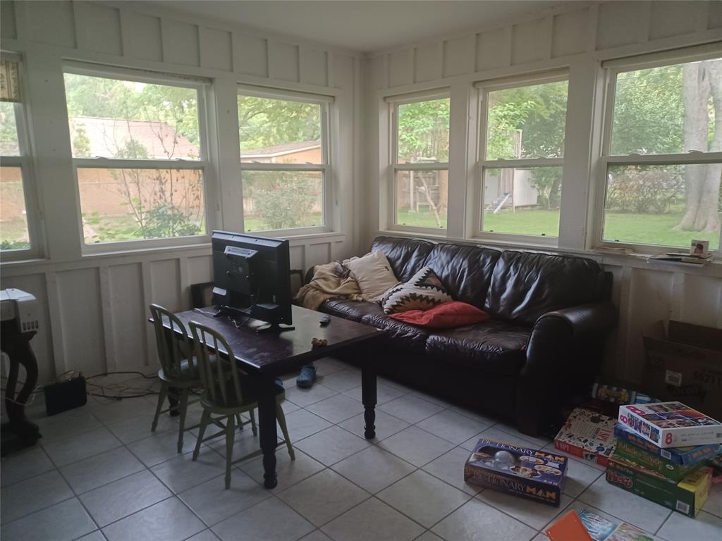 415 Magnolia Street Denton, TX 76201 - Photo 18 of 23 a living room with furniture and floor to ceiling windows