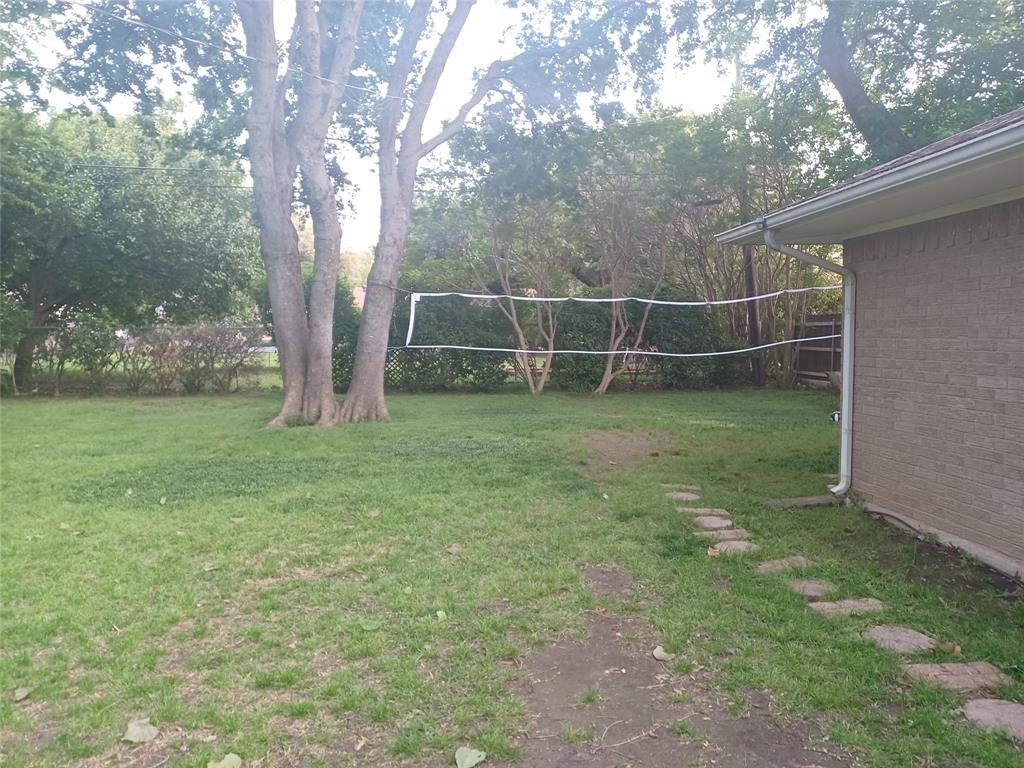 415 Magnolia Street Denton, TX 76201 - Photo 20 of 23 a view of a yard with a tree