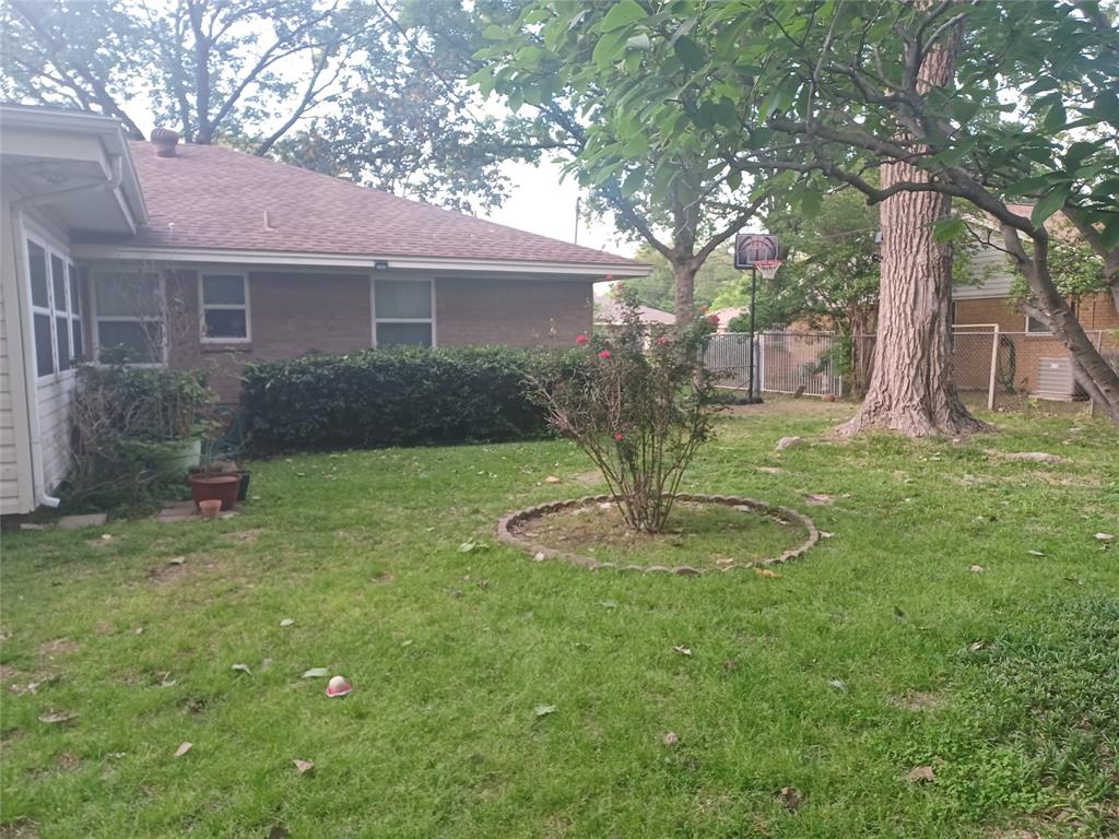 415 Magnolia Street Denton, TX 76201 - Photo 22 of 23 a backyard of a house with fountain and barbeque oven