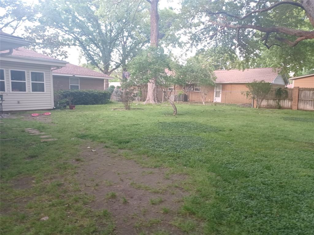 415 Magnolia Street Denton, TX 76201 - Photo 23 of 23 a view of a backyard with large trees