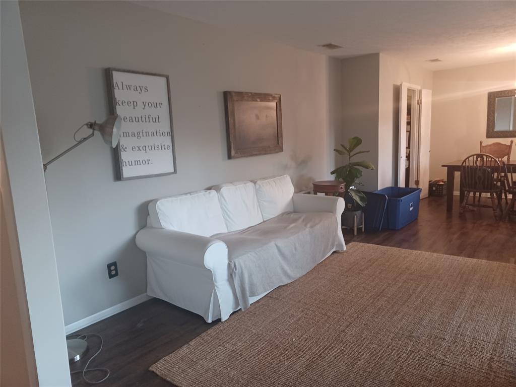 415 Magnolia Street Denton, TX 76201 - Photo 6 of 23 a living room with furniture and a wooden floor