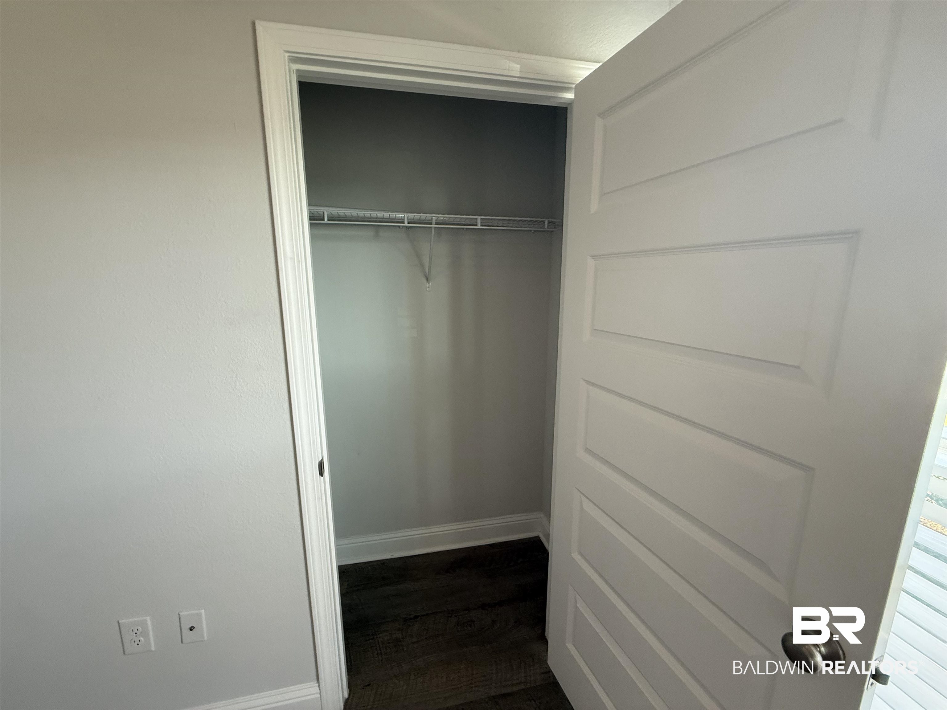 23247 Lieutenant Avenue Foley, AL 36535 - Photo 14 of 47 Closet featuring dark wood-finish flooring, light grey walls, and a wire shelving system