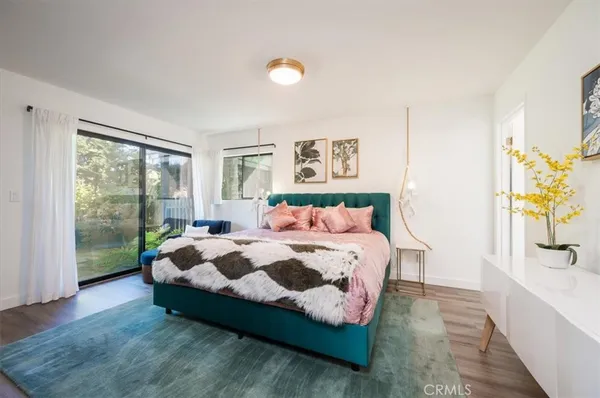 a bedroom with a bed and a painting on the wall