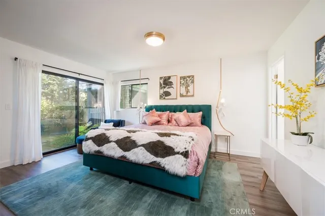 a bedroom with a bed and a painting on the wall