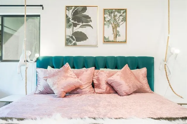 a bedroom with a bed and a painting on the wall