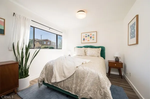 a bed sitting in a bedroom next to a window
