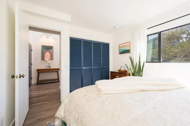 a bedroom with a bed and a painting on the wall