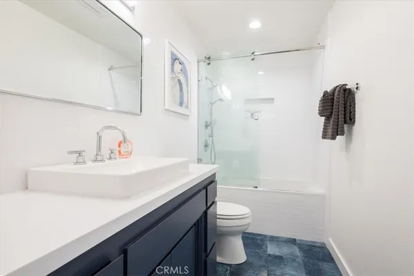 a bathroom with a sink a toilet and mirror