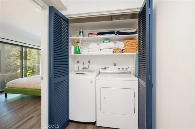 a view of a balcony with wooden floor and outdoor seating