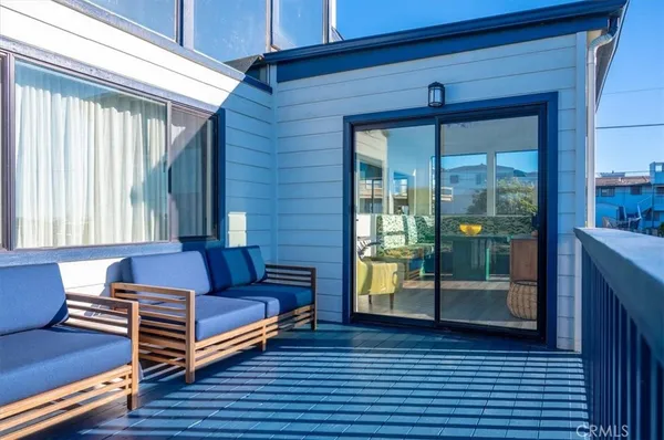 a view of balcony with wooden floor and fence