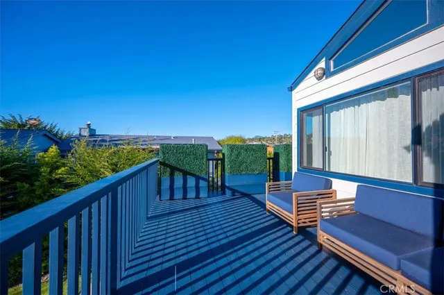 a view of a patio with table and chairs potted plants and a large tree
