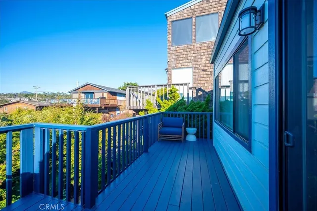 a front view of a house with a yard and tree