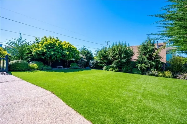 an aerial view of a house with a yard and garden