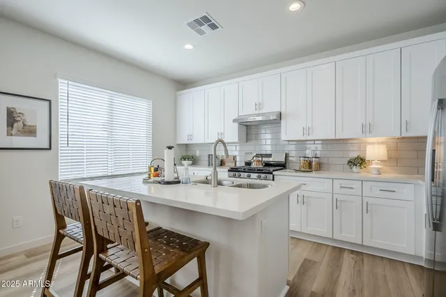 a kitchen with a stove and cabinets