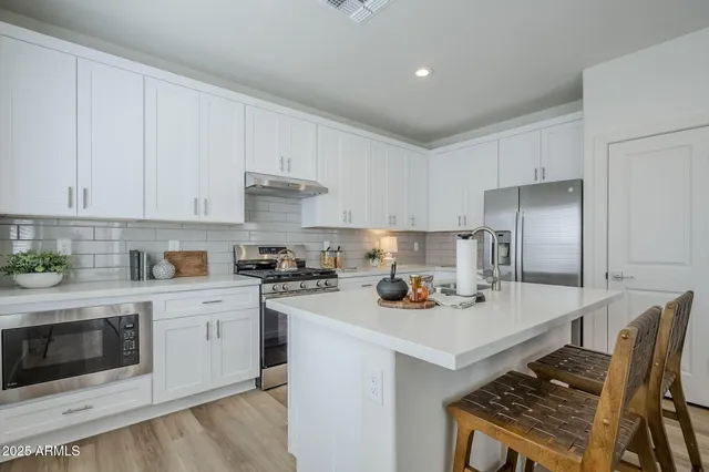 a kitchen with sink a stove and refrigerator