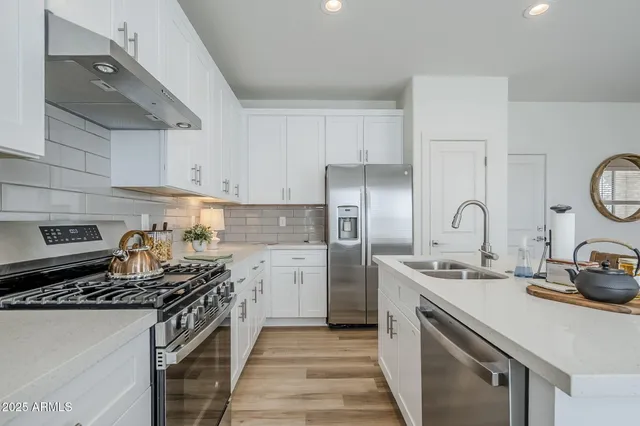 a kitchen with a sink and a refrigerator