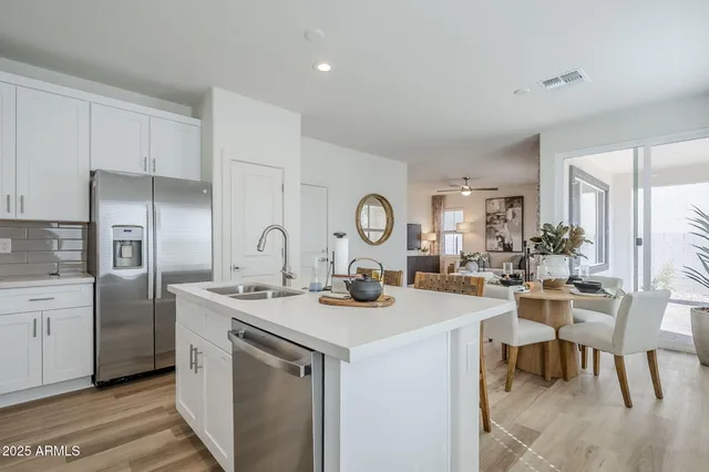 a kitchen with sink a stove and cabinets