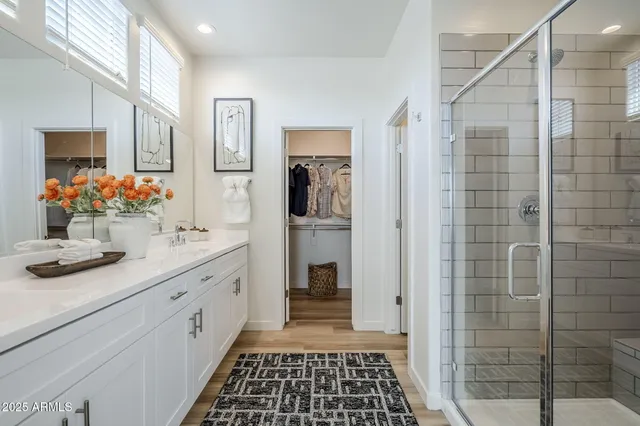 a view of walk in closet with clothes