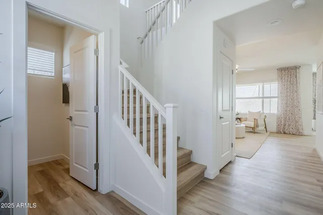 a view of entryway with wooden floor and stairs