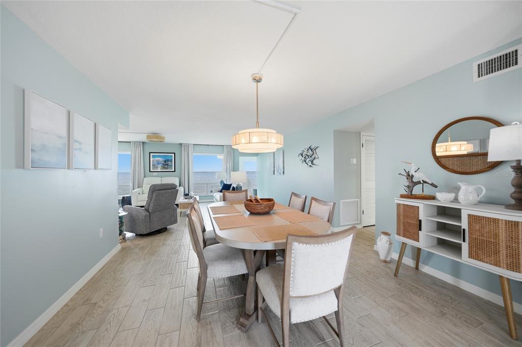 1 Colony Point Drive, Unit A10 Punta Gorda, FL 33950 - Photo 13 of 31 a dining room with wooden floor a chandelier a wooden table and chairs