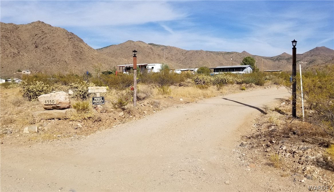 4550 Smoketree Road Golden Valley, AZ 86413 - Photo 1 of 38 a view of a road with a snow on the road