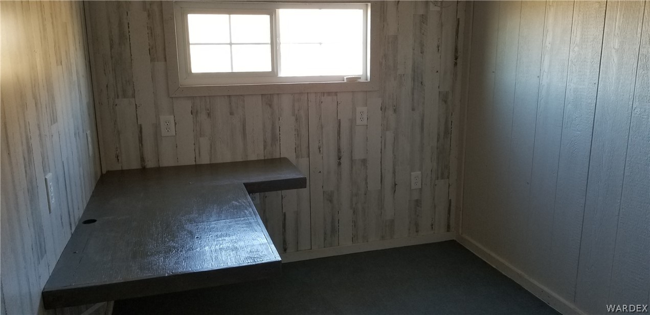 4550 Smoketree Road Golden Valley, AZ 86413 - Photo 11 of 38 an empty room with wooden floor and windows