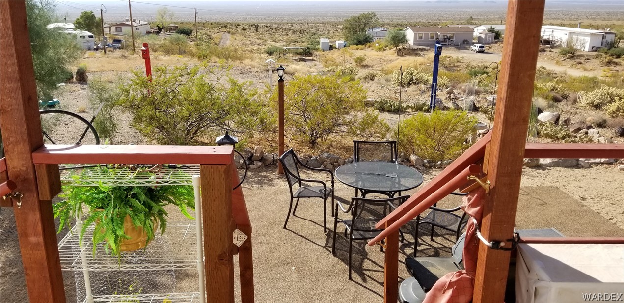 4550 Smoketree Road Golden Valley, AZ 86413 - Photo 17 of 38 a view of a balcony with chairs
