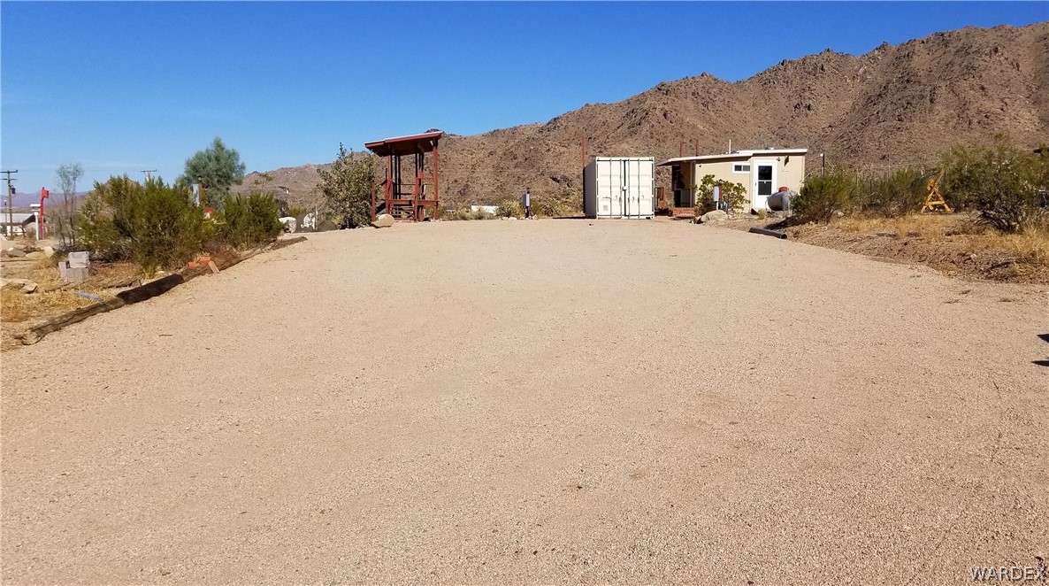 4550 Smoketree Road Golden Valley, AZ 86413 - Photo 3 of 38 a view of a house with a snow in the yard