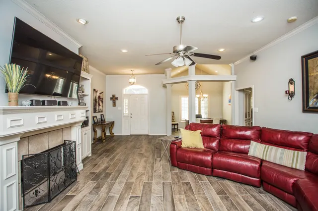 a living room with furniture a fireplace and a flat screen tv