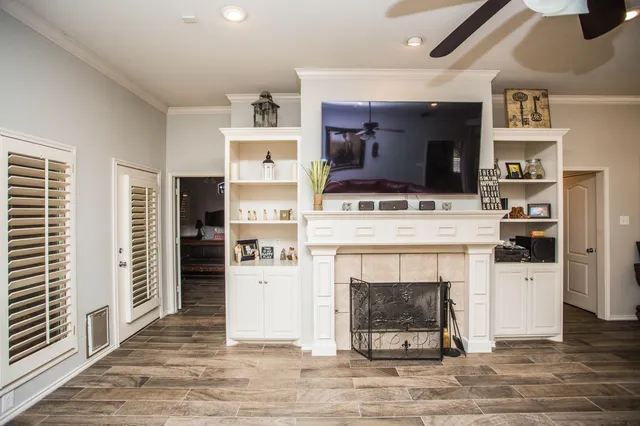a living room with furniture fireplace and flat screen tv