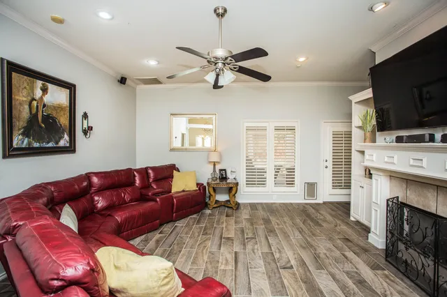 a view of a living room with wooden floor and furniture