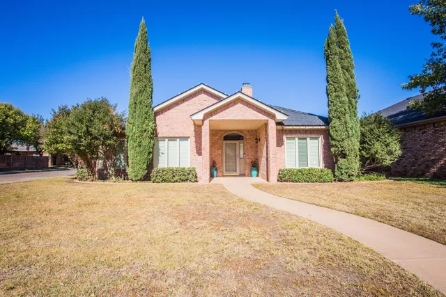 a front view of a house with a garden and entryway