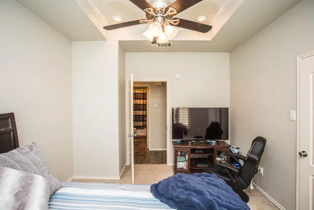 a bedroom with furniture and a flat screen tv