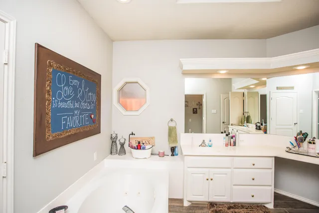 a view of walk in closet with clothes