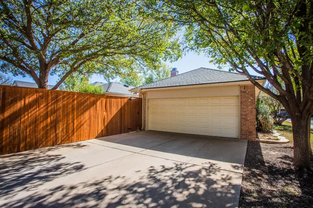 a view of a small house with garage