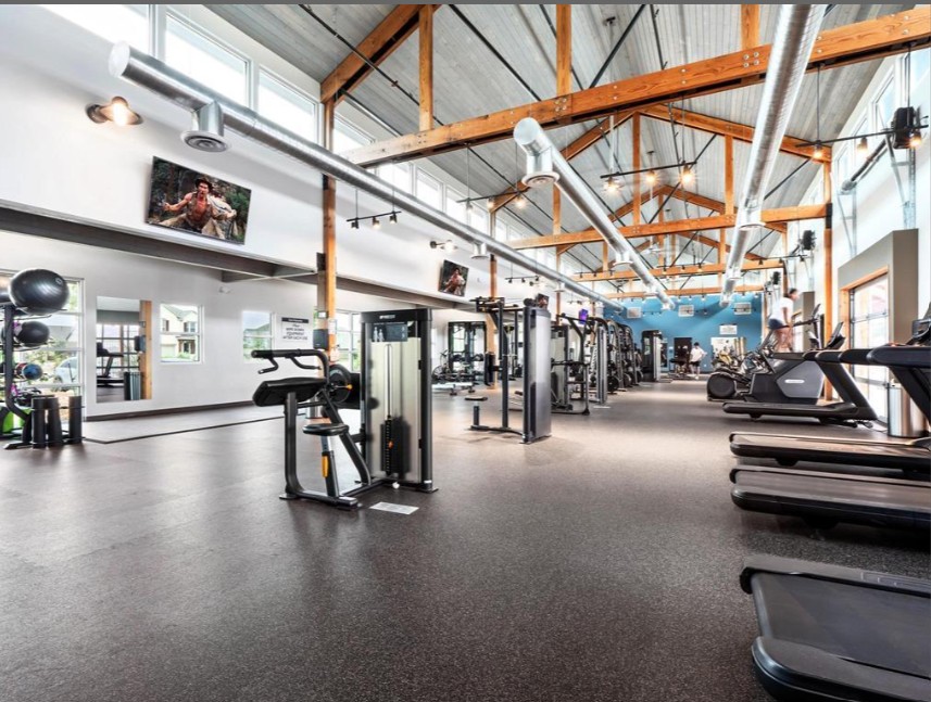 20813 Carries Ranch Road Pflugerville, TX 78660 - Photo 39 of 40 Massive exposed timber trusses soar over this fully equipped fitness space.