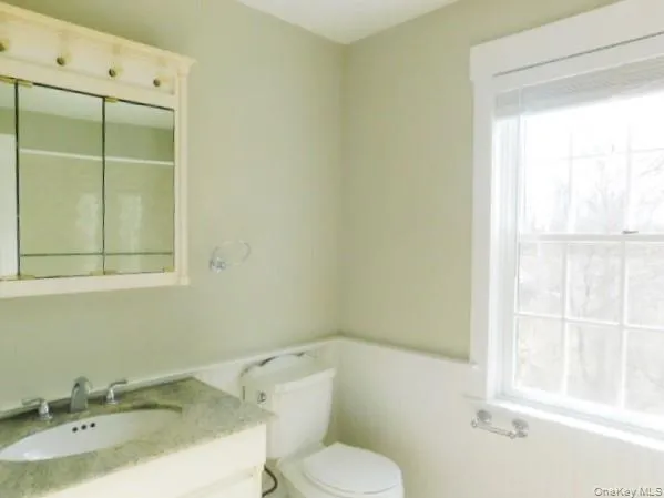 a kitchen with stainless steel appliances granite countertop a sink dishwasher a stove and a refrigerator with wooden cabinets