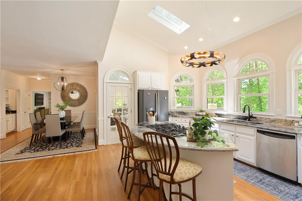 2935 Coles Way Atlanta, GA 30350 - Photo 19 of 56 a dining room with furniture window wooden floor and a chandelier
